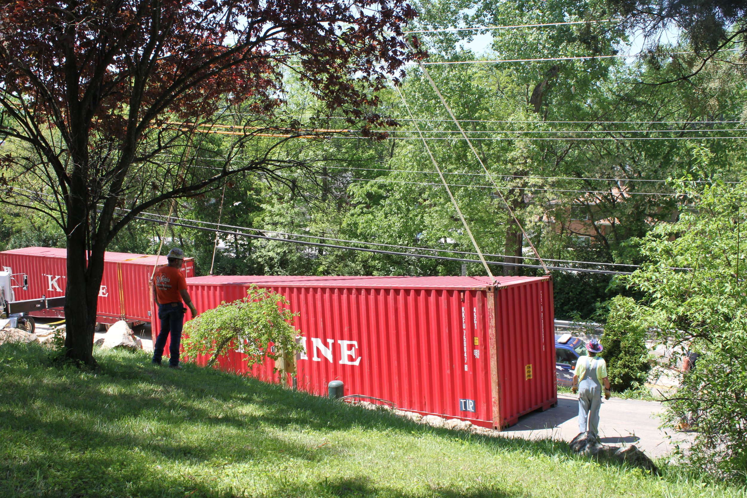 Crane hooking up to container